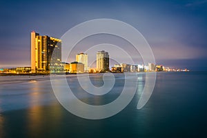 Highrises along the Gulf of Mexico at night, in Panama City Beach, Florida photo