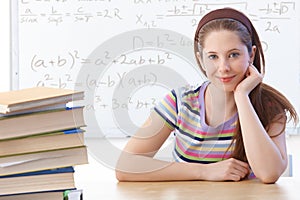 Highschool student smiling front of whiteboard