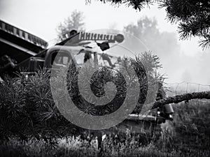 HIGHT SPEED TRACK DOZER ON BACKGROUND OF PINE BRANCHES