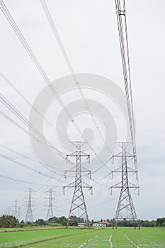 Hight voltage tower line on the cloudy sky background.