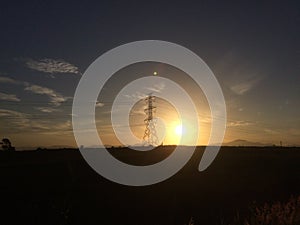 Hight volte electric tower with sunrise. photo