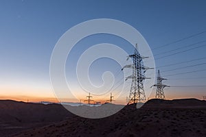 Highvoltage lines pylons in the field