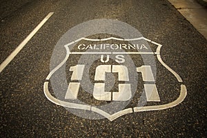 Highway 101 sign painted on the black asphalt road