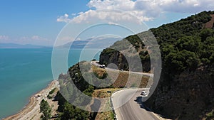 A highway along the Beysehir lake in Turkey. Aerial view of the coastline road. Cars driving along the shore