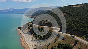A highway along the Beysehir lake in Turkey. Aerial view of the coastline road. Cars driving along the shore