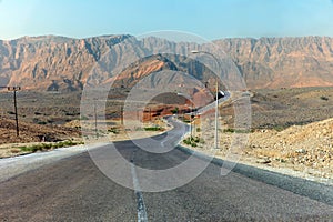 Highway along high lifeless mountains in Oman