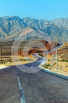 Highway along high lifeless mountains. Oman