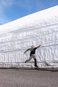 Highway along the snow wall. Norway in spring