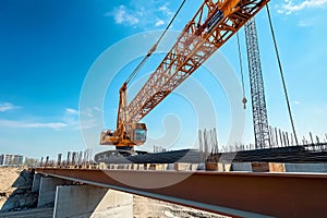 Highway bridge construction site with crane under clear blue sky