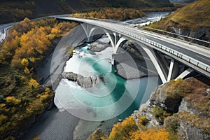 highway bridge over clear, winding river with waterfalls