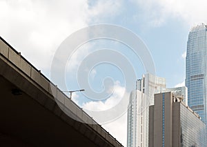 Highway bridge with street light and business skyscrappers with blue sky photo