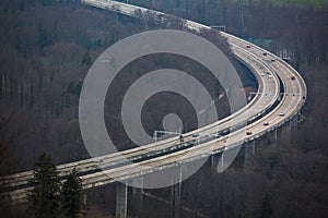 Highway on columns in a valley from afar and above