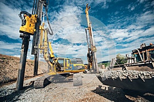 Highway construction with heavy duty machinery. Two Rotary drills, bulldozer and excavator working