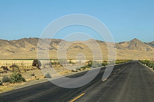 Highway crossing a mountainous and desert area of California, US
