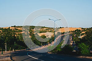 Highway curve road overpass nature landscape background dark tone mist day time street tall lanterns trees bushes