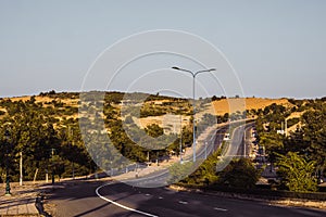 Highway curve road overpass nature landscape background dark tone mist day time street tall lanterns trees bushes