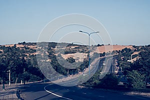 Highway curve road overpass nature landscape background dark tone mist day time street tall lanterns trees bushes