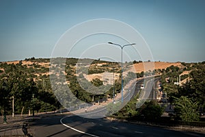 Highway curve road overpass nature landscape background dark tone mist day time street tall lanterns trees bushes