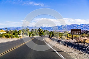 Highway through Death Valley National Park, Furnace Creek 190 feet below sea level sign on the side of the road; Calfiornia photo