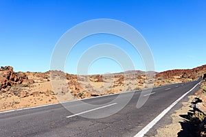 Highway in desert landscape with clear blue sky