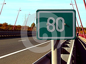 Highway detail in diminishing perspective and 80 km distance or milage sign