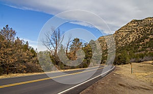 Highway disappearing around a rock