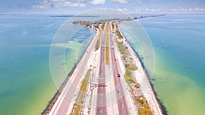 Highway or Freeway road. Ocean or Gulf of Mexico. Road for cars and truck. Low traffic on the way. Highway for any transportation.