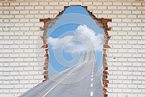 Highway going through a broken brick wall,