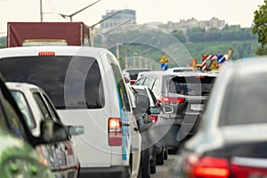 Highway interstate road with car traffic jam and Kiev on background. Motorway bumber barrier gridlock due country border control