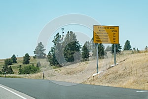 Highway Interstate road sign, alerting truckers and semi drivers to axle weight limitations and speed limits