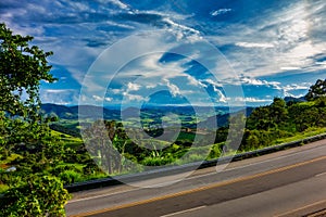 Highway with Landscape of hills with blue sky in the background. Road in mountainous region in Minas Gerais, Brazil