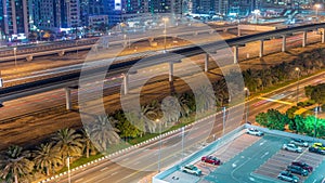 Highway near Dubai marina skyscrapers night timelapse.