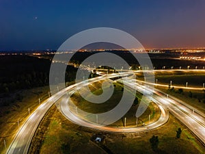 Highway road junction at night, aerial view