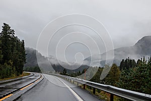 Highway road in a misty mountains of Norway