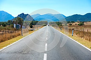 Highway road with mountains on horizon