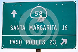 Highway road sign in California gives directions for Highway State Route 58, toward either Santa Margarita or Paso Robles in