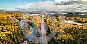 Highway Road by vibrant fall season color trees. Sunny Sky Aerial View. Newfoundland, Canada