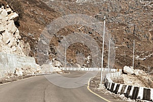 Highway road view of India China border near Nathu La mountain pass in Himalayas which connects Indian state Sikkim with China`s