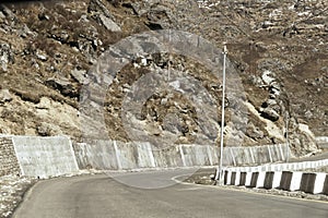 Highway road view of India China border near Nathu La mountain pass in Himalayas which connects Indian state Sikkim with China`s