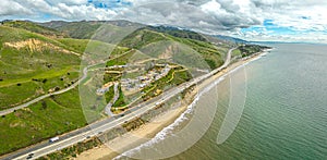 Highway Route 1 California. Aerial Panorama of the coastline and road. Green hills and beach on side