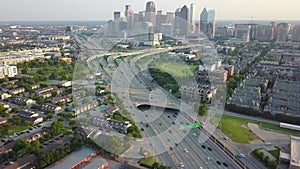 highway route 75 city traffic and Dallas downtown panorama, camera raises, evening Texas