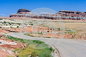 Highway running through colorful painted desert in central Utah near Canyonland Zion Bryce and Goblin Valley photo