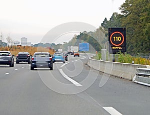 highway sign with speed limit of 110 km and the text RAPPEL which means REMEMBER in French