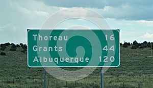 Highway sign for the towns of Thoreau, Grants and Albuquerque
