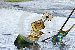 Highway signs on flooded road