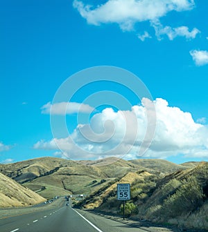 Highway between small hills in Central California