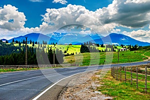 Highway in snow-capped peaks.