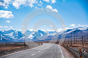 Highway by the snow mountain in high altitude region