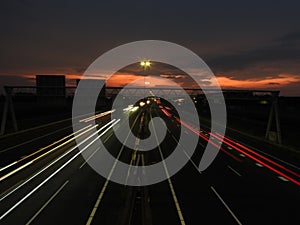 Highway in sunset with cars and a bike perspective from above