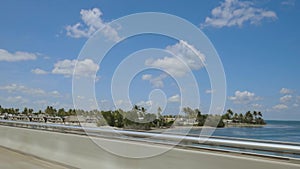 Highway to Key West Florida. View of old abandoned bridge and coast line of Atlantic ocean on blue sky.